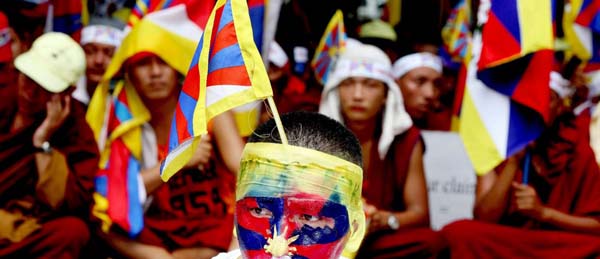 Tibetan activists hold flags during a rally