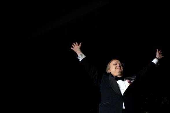 Karl Rove raises his hands to the crowd after dancing