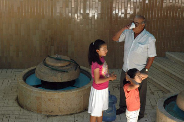 A man drinks from the only natural drinking water spring left in Tehuacan