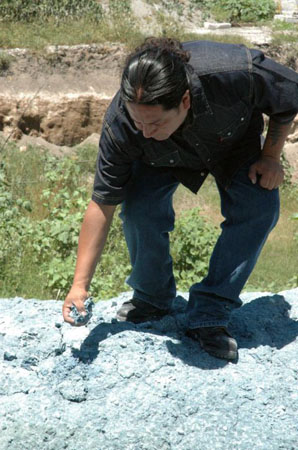 Activist Martin Barrios picks up some of the blue residue