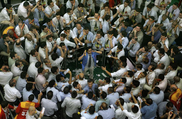 Stock traders negotiate at the future dollar pit