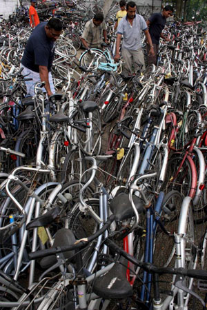 Customers choose from a heap of used bicycles