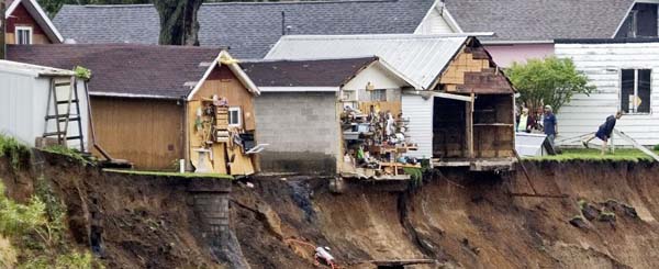Houses on the edge of a bank following flooding