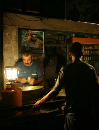 A Palestinian man waits to buy falafel at a fast food shop