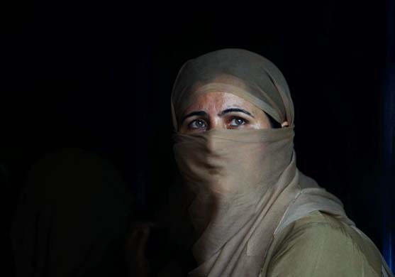 A Jammu Kashmir policewoman looks on during a protest rally by unemployed engineers