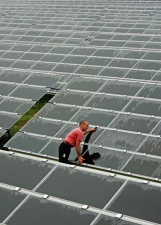 A technician checks modules in a new solar power station