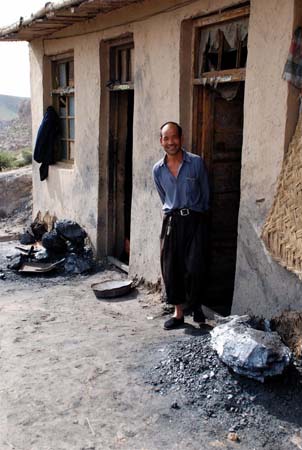 A miner steps out of his hut