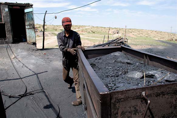 An iron boxcar loaded with coal