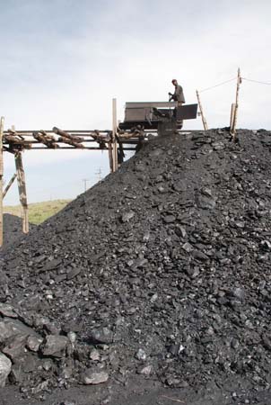 A wooden pier above the coal heap