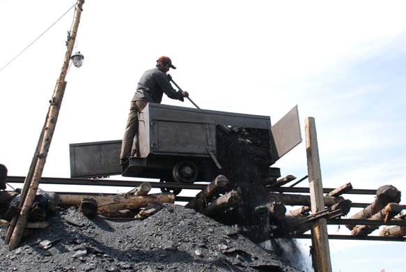 Black dust billows out as Ma unloads another tonne of coal above the jerry-built wooden pier