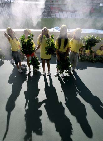 Children cool off before rehearsals for the opening ceremony for the 11th IAAF World Championships