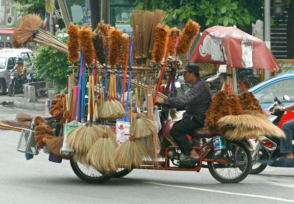 Broom seller on rickshaw