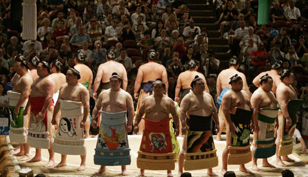 Wrestlers parade around the ring