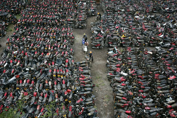 Workers prepare to destroy illegal motorbikes