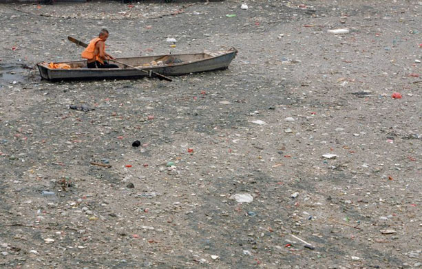 rubbish floating on a canal