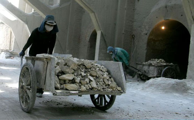 Labourers work at a lime factory