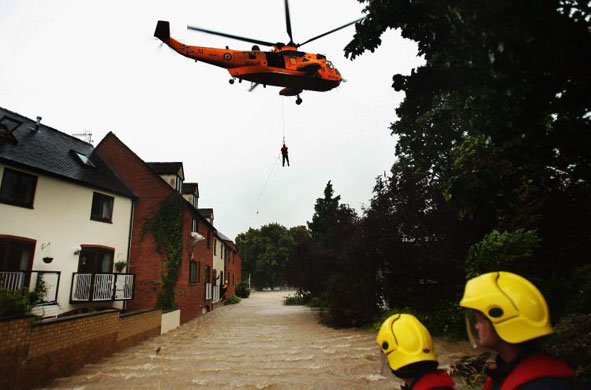 A local resident is air lifted from their home