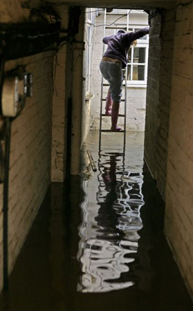 A local resident attempts to re-enter her house in Evesham