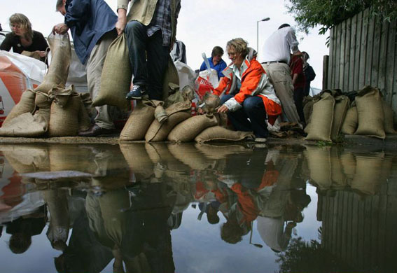 Members of the public fill sandbags