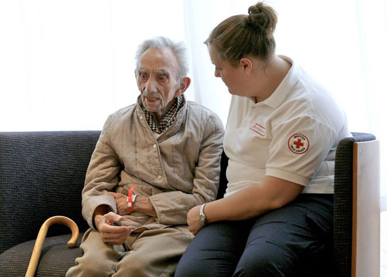 A member of the British Red Cross talks to a flooding victim