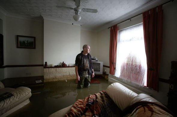 Norman Aitken surveys the damage to his home
