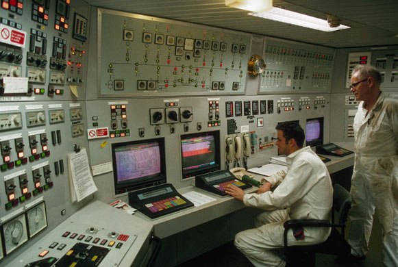 Engineers work in the main control room