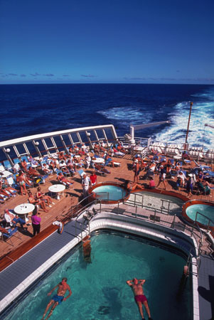 Passengers use the pool and sundeck