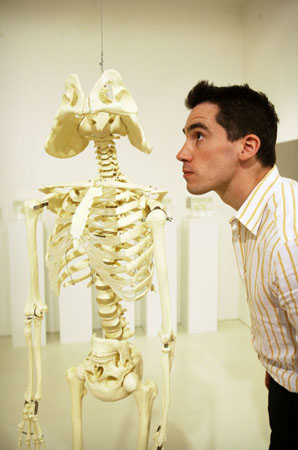 A visitor looks at a skeleton