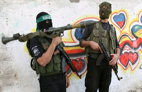 Hamas masked militants stand guard
