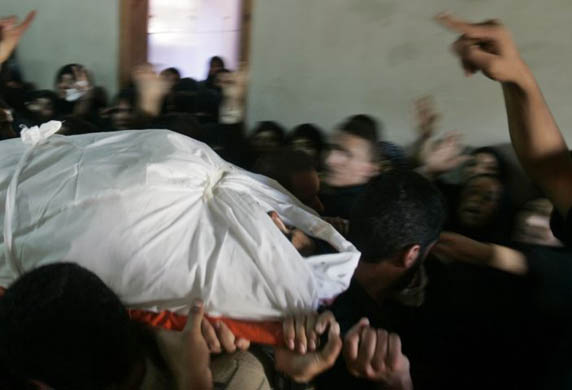Palestinians carry the body of Hamas security force officer Maher Abu Teir