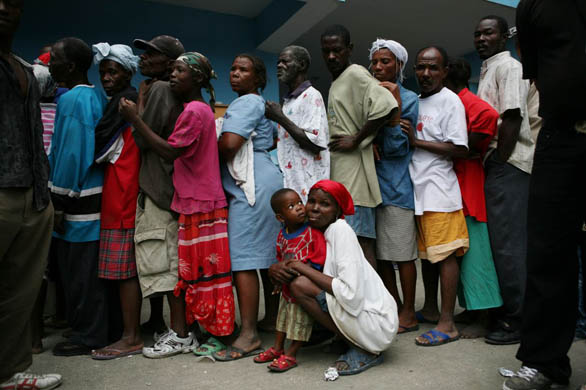 Refugees line up to get food and supplies from UN peacekeepers