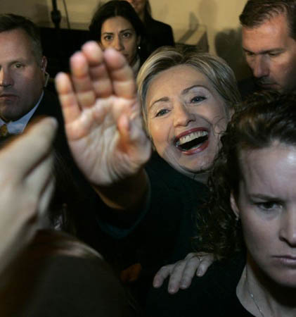 Democratic presidential hopeful senator Hillary Rodham Clinton reaches through security agents to shake a hand after her campaign speech