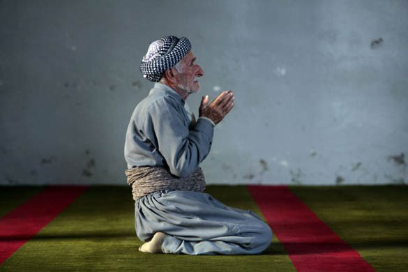 An Iraqi Kurd attends Friday prayers at the Grand Mosque