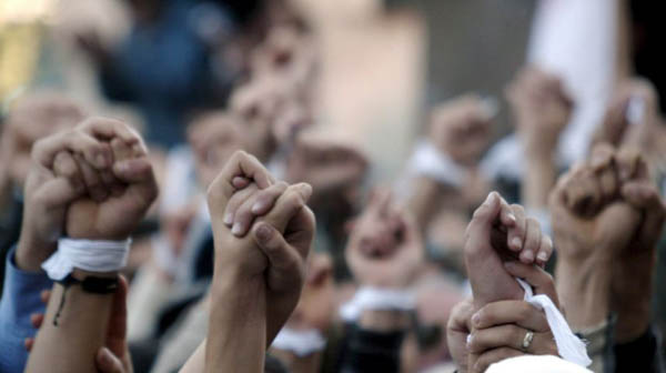 Participants of the opposition link their arms during a rally in front of Parliament building