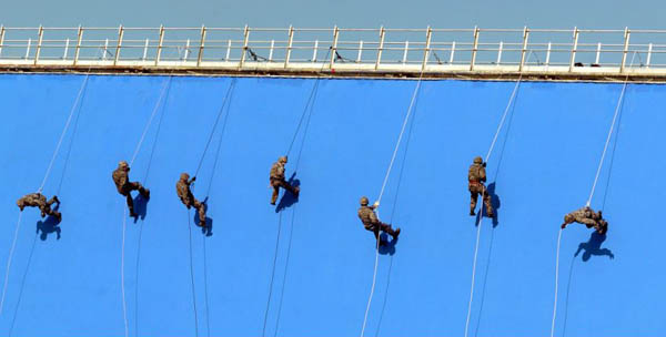 Stuntmen perform for the Queen as she unveils a new entrance to Pinewood Studios 