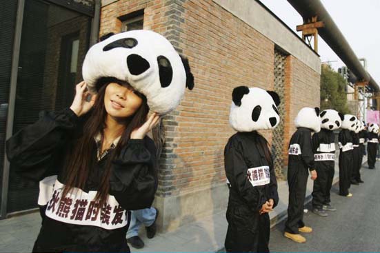 People dressed as pandas before an art show