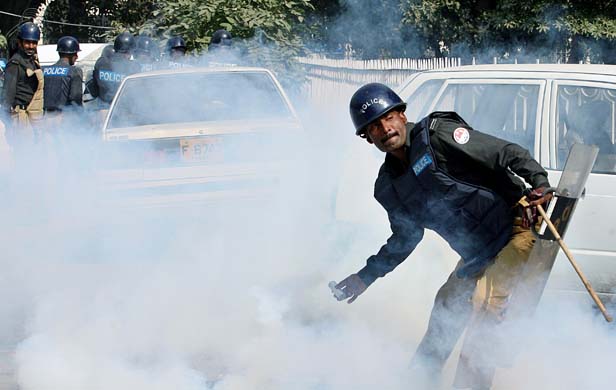 Pakistani policeman throws teargas