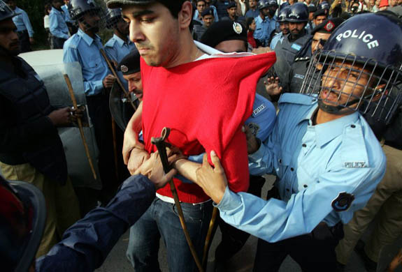 Policemen arrest a civil rights activist