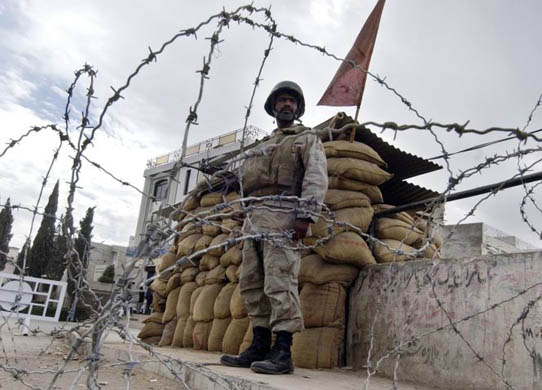 A paramilitary soldier stands on a roadside in Quetta