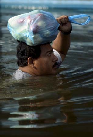 A man makes his way through the floodwaters