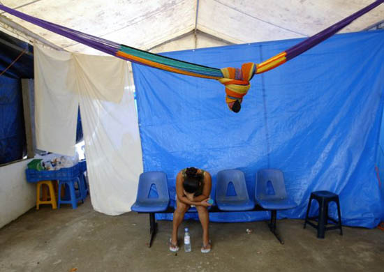 A woman waits for her relatives at the Red Cross