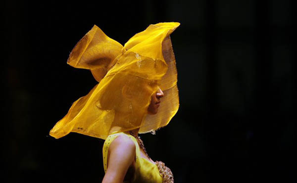 A model shows a creation during a show for Beijing Fashion Week