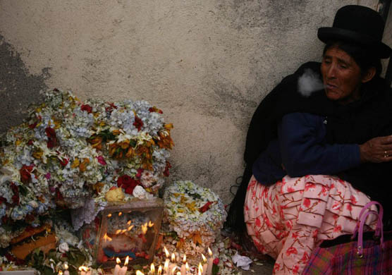 A woman sits in a cemetary relative the Day of the Skulls' celebrations