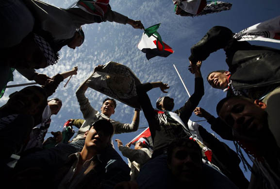 Palestinians dance during a ceremony to mark the third anniversary of the death of Yasser Arafat