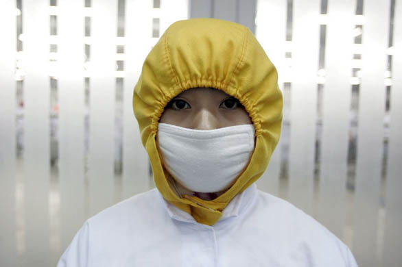 A worker wears protective clothing at the Huadu chicken processing company