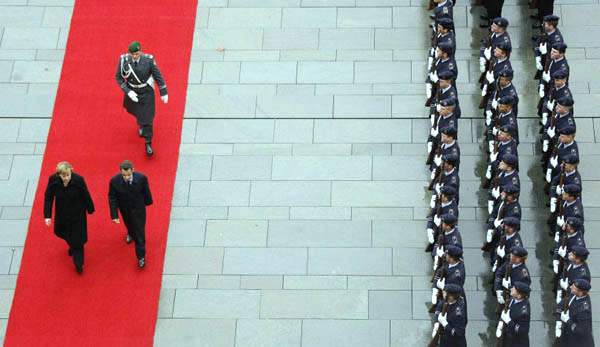 Angela Merkel and Nicolas Sarkozy reviewing honour guards at the Chancellery during a Franco-German Inter-Ministerial meeting