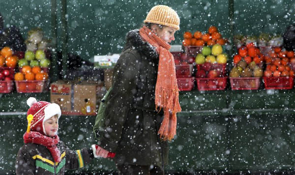 A mother and her child pass by a street market 