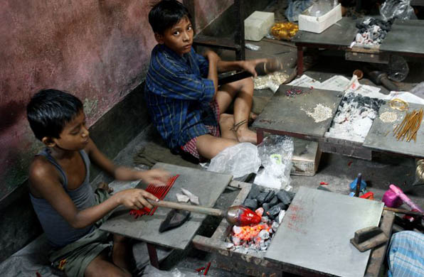 Child labourers at work in a small plastic moulding factory