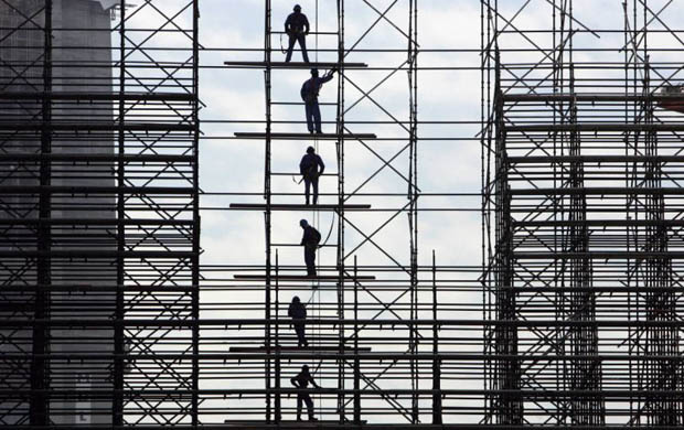 Labourers work at a construction site