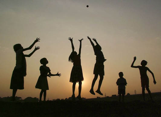 Children play near the banks of the river Daya